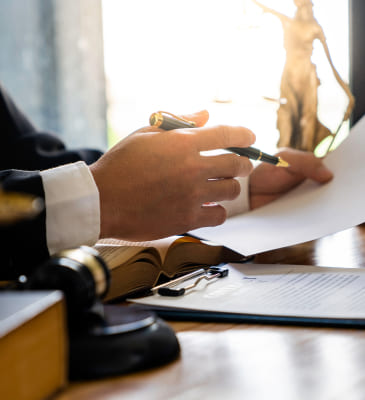 A person holding a pen and paper