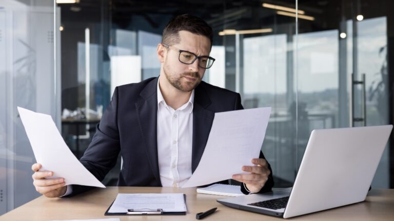 worried man reviews documents
