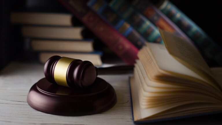 Wooden hammer on the books background