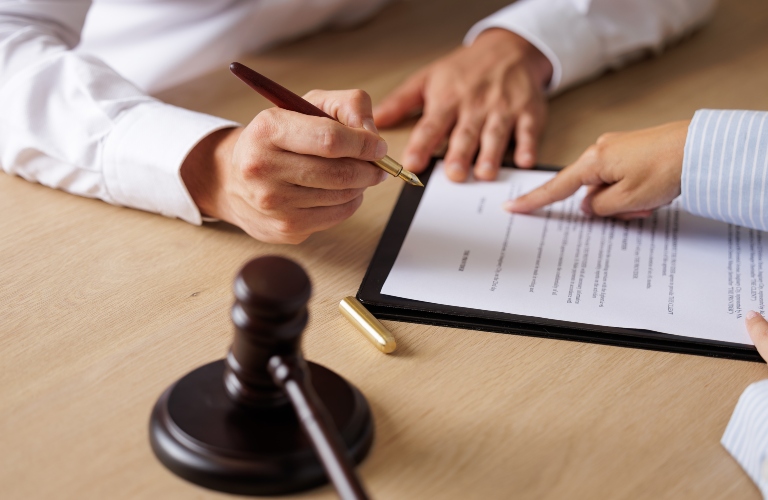 lawyer shows client where to sign document