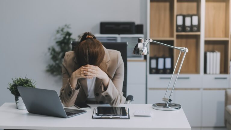 woman sits with head down after receiving letter