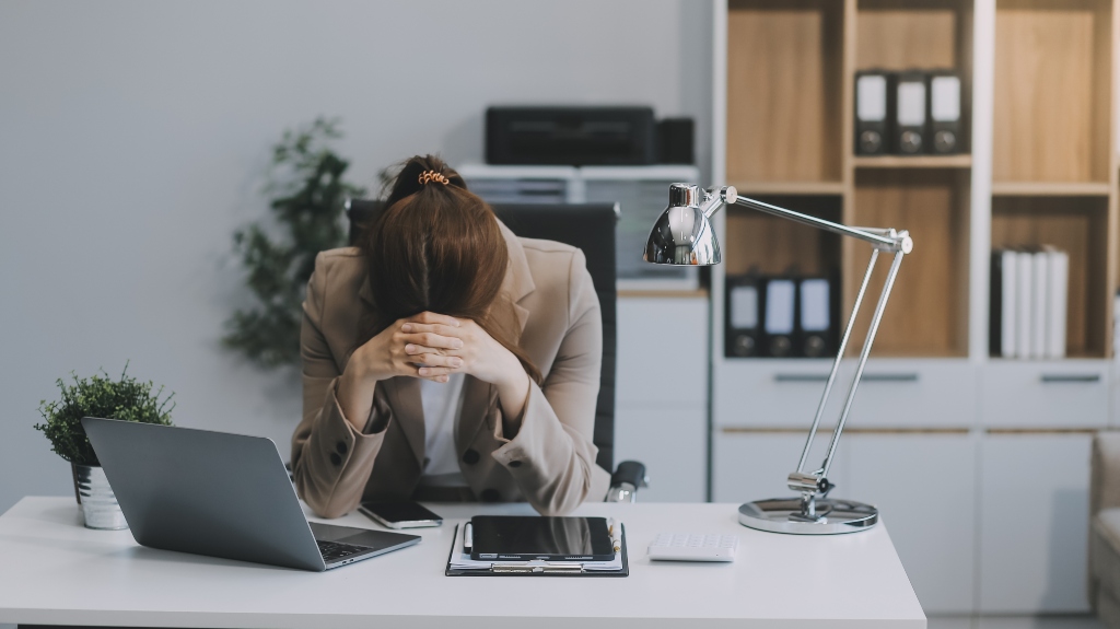 woman sits with head down after receiving letter