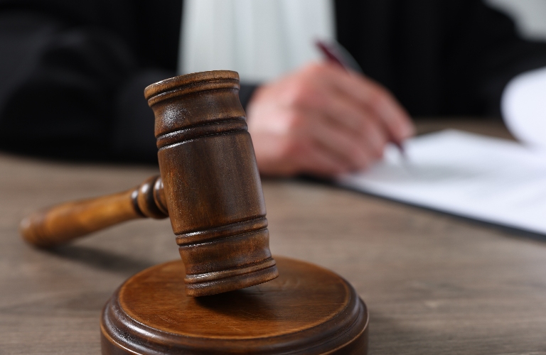 Judge with gavel writing in papers